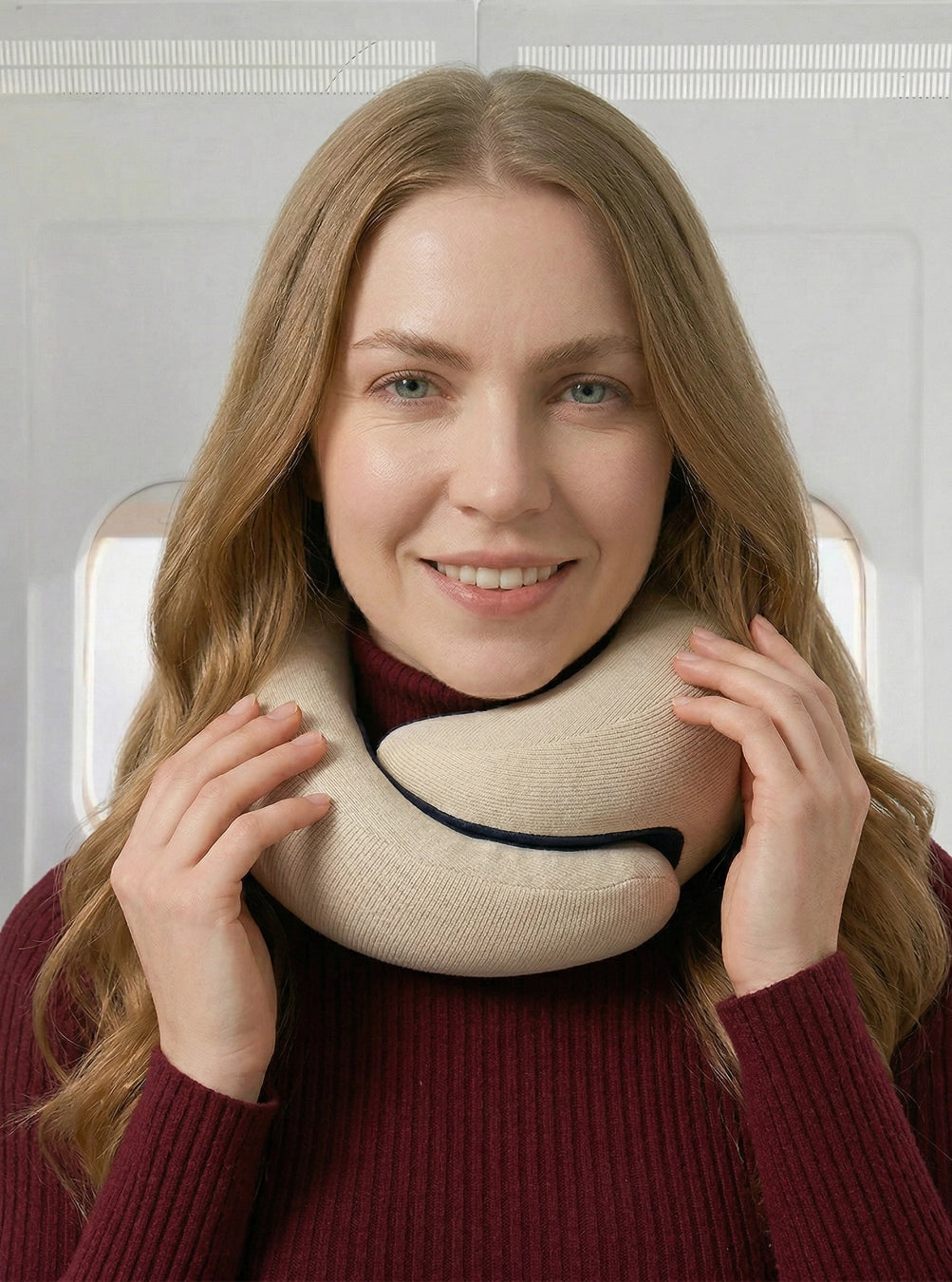 Woman wearing a beige travel neck pillow on an airplane, cloudwhite