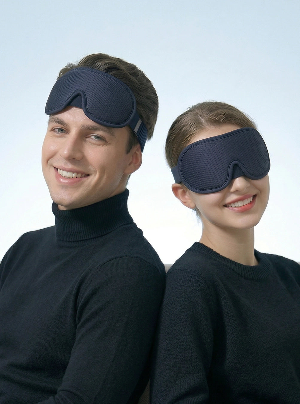 Two people wearing navy blue sleep masks against a light gray background, eclipseblue