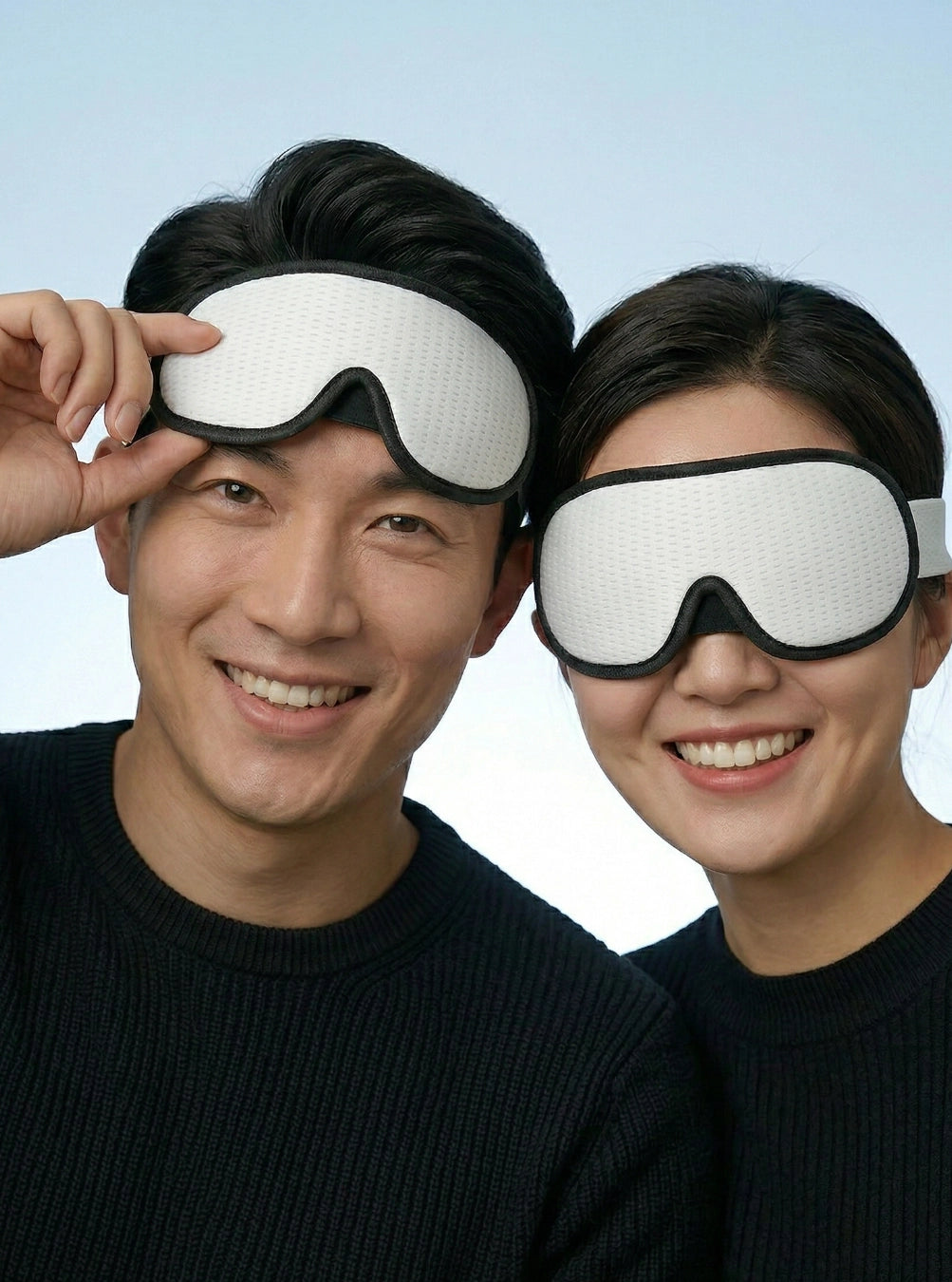 Two people wearing white sleep masks against a light blue background, cloudwhite