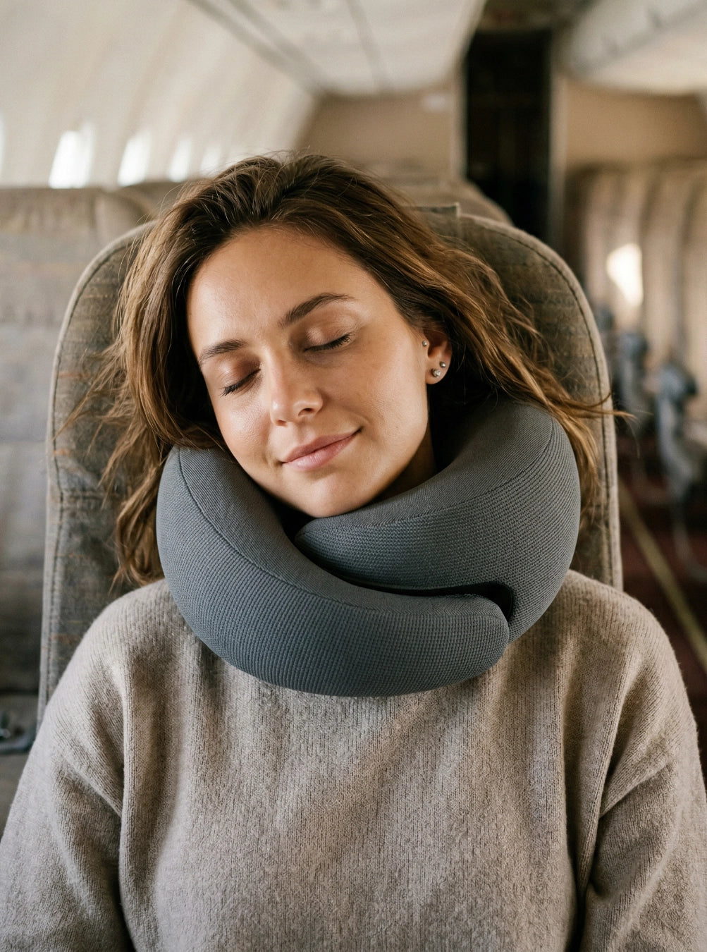 Woman using a neck pillow on an airplane, spaceblack